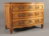 an antique chest of drawers with a wooden top and brass handles