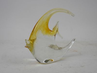 a glass fish that is sitting on a table