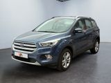 the blue ford kuga is parked in a large room
