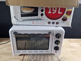 two microwaves stacked on top of each other on a table