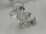 two clear glass figurines of a dog and a cat on a table