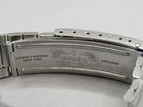 a close up of a watch on a white surface