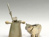two figurines of animals that are standing next to each other