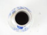 a blue and white vase on a white table