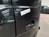 a black car with a sticker on it parked in a parking lot