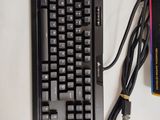 a black keyboard and a charger on a white table