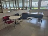 a room with a table, chairs, and a piano in it