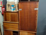 a wooden cabinet with drawers and a box on top