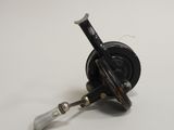 a close up of a fishing reel on a white surface