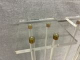 a glass table with four candles on top of it