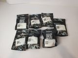 six packets of tea sit on a table with a white table cloth