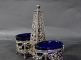 two silver and blue glass dishes on a gray surface