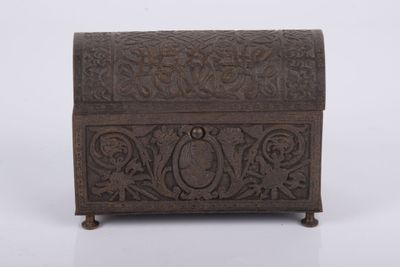 an old wooden box with carvings on it on a white surface