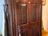 a large wooden cabinet in the corner of a room
