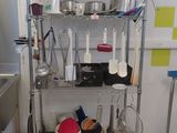 a metal shelf with pots and pans on top of it