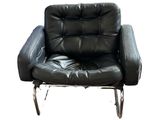 a black leather chair that is sitting on a white background