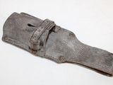 an old knife that is laying on a white surface