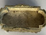 a small gold box with a handle on a table