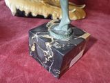 a statue of a woman on a pedestal on a red carpet