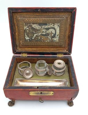 a small wooden box with a set of rings inside of it