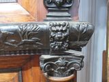 a close up of a wooden door handle with a lion head on it