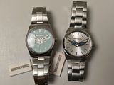 two watches sitting next to each other on a table