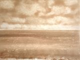a sepia photo of a person on a surfboard in the ocean