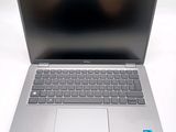 an open laptop computer sitting on top of a white table