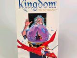 the box for the game kingdom is sitting on a white surface
