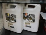 two bottles of motor oil on a shelf in a store