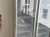 two refrigerators that are open in a room
