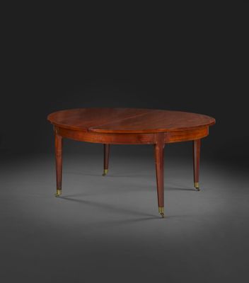 une table ovale en acajou avec des pieds en laiton