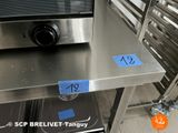 a stainless steel counter with a microwave on top of it