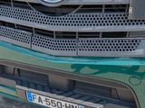 a close up of a green mercedes truck with a police badge on the front of it