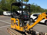 a small excavator that is parked in a parking lot