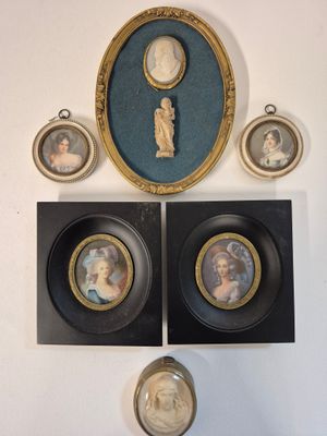 three framed pictures of a woman and a child are on a wall