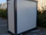 a small white box in the middle of a parking lot