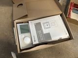 a cardboard box with a digital device inside of it