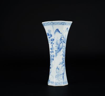 a blue and white vase with a design of flowers and birds on it