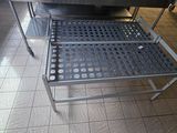 tiled floor in a restaurant kitchen with a stainless steel table and chairs