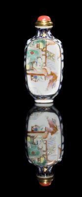 a glass bottle with a painting on it sitting on a table