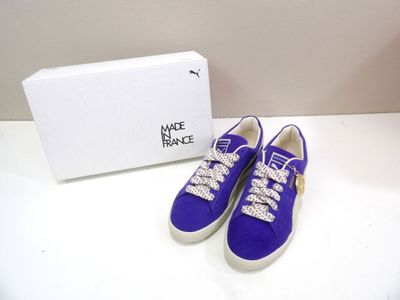 purple sued sneakers with crystal embellishments and a white box