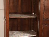 a wooden cabinet with a door open in a room