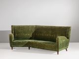 an image of a green couch sitting on top of a white floor
