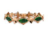 une photo d'un bracelet en or orné de pierres vertes