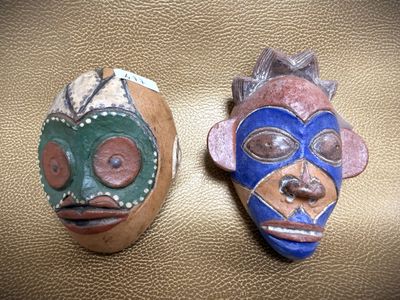 two masks that are sitting on a table