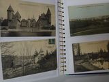a hand holding an open book with pictures of a castle