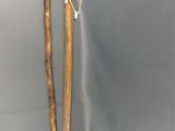 pair of wooden walking sticks on a grey background