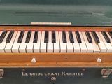 a green case with a piano inside of it
