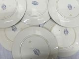 several white plates with blue designs are stacked on top of each other